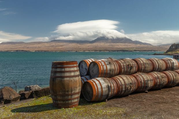 Whisky-Fässer bei Bunnahabhain mit Blick auf die Insel Jura