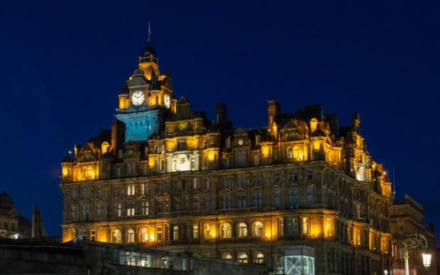 Ein Blick auf das nächtlich beleuchtete Balmoral Hotel mit seinem Turm.