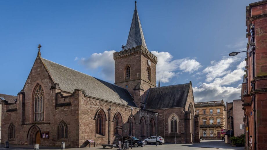 Die Kirche St. John’s Kirk mit einem Turm in der Mitte. Blauer Himmel darüber.